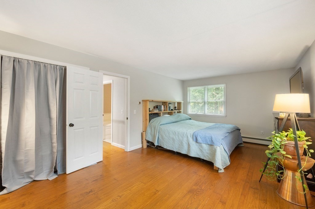 147 Wales Road Monson, MA 01057 - Photo 36 of 41 a bedroom with a bed table flowerpot and window