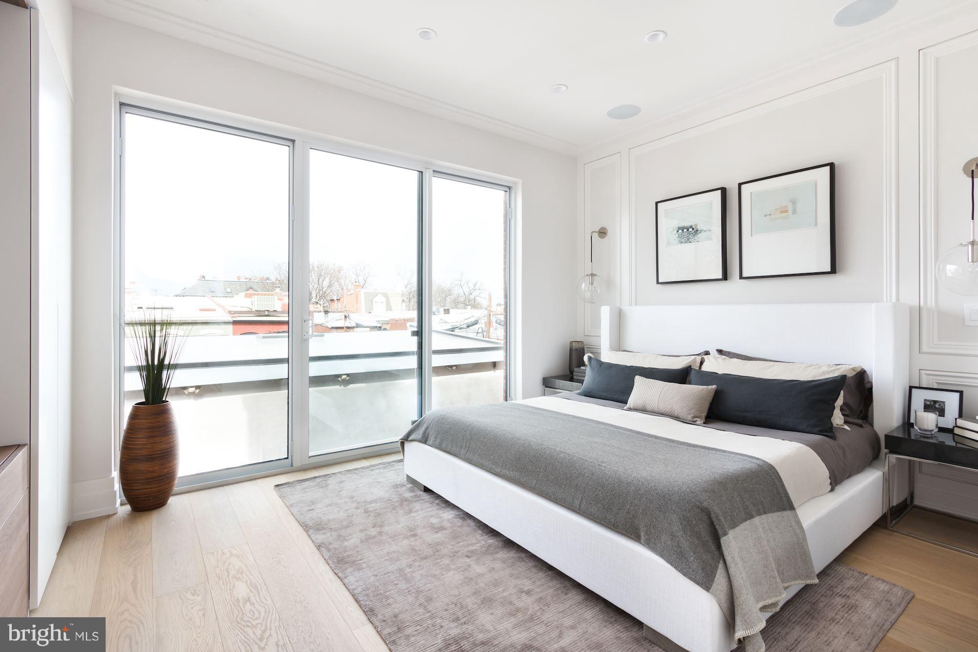 422 C Street Northeast Washington, DC 20002 - Photo 12 of 19 a bedroom with a large bed and a large window