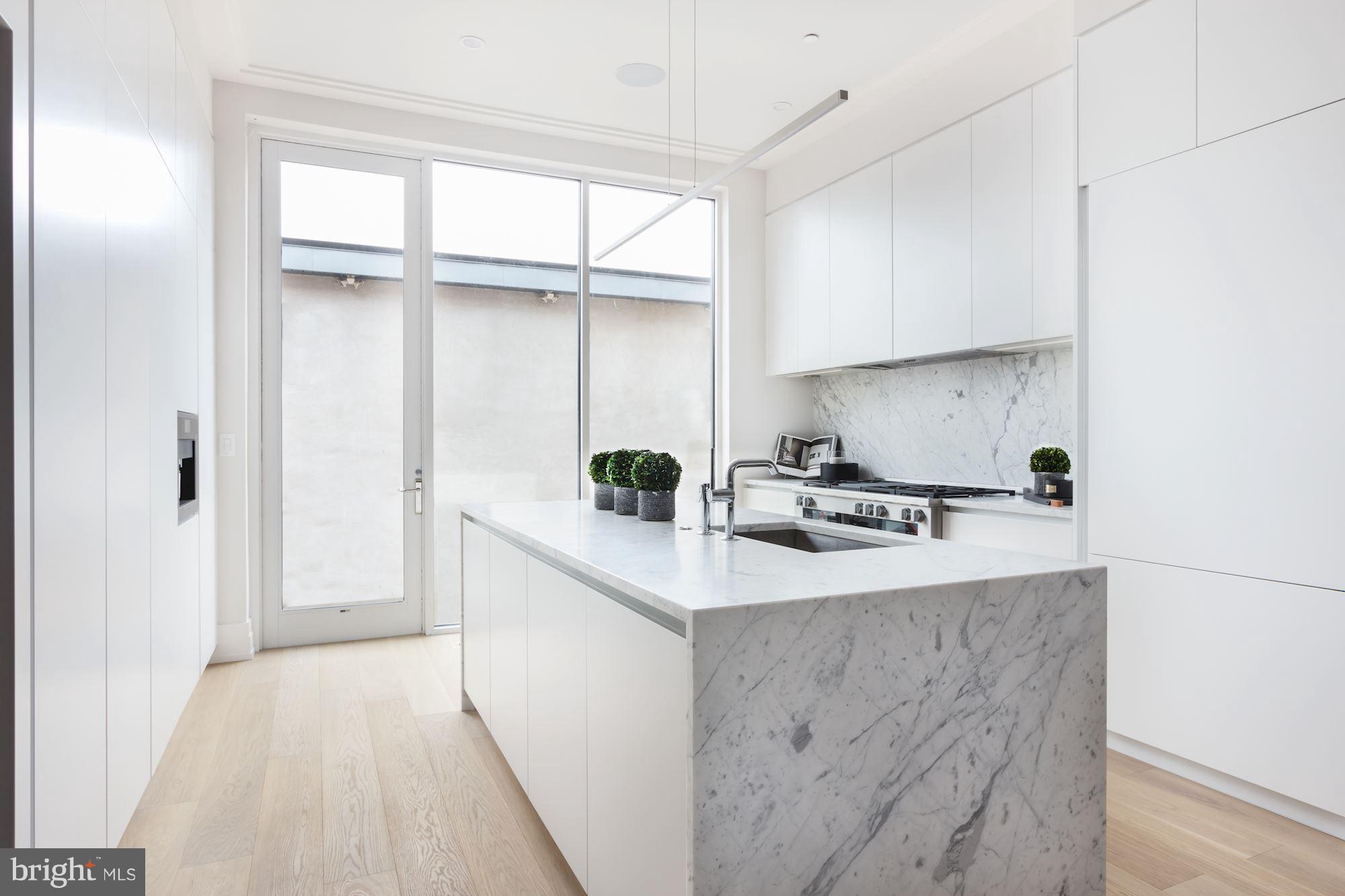 422 C Street Northeast Washington, DC 20002 - Photo 9 of 19 a kitchen with stainless steel appliances a sink stove and cabinets