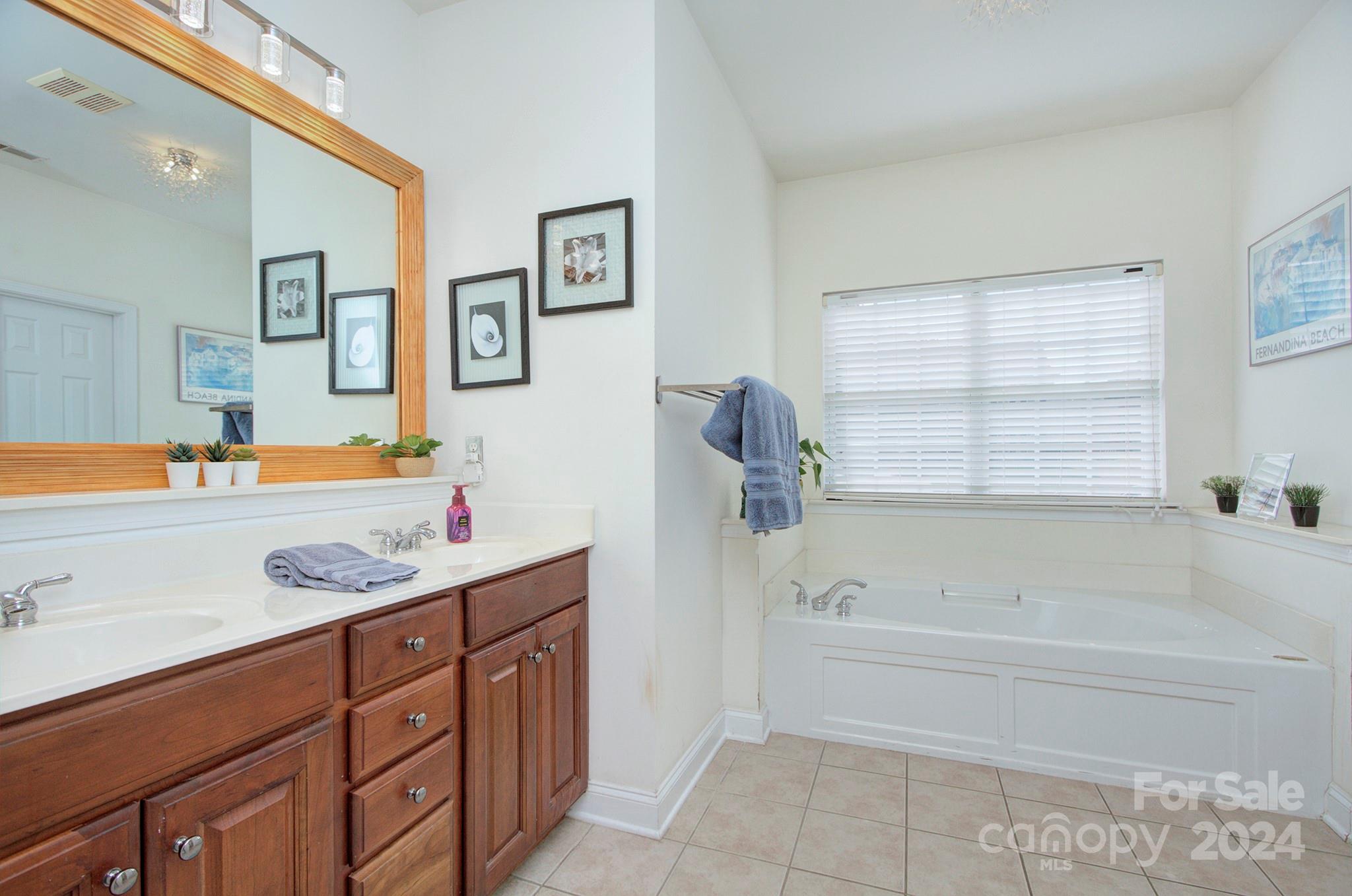144 Lighthouse Road Mount Holly, NC 28120 - Photo 15 of 48 a bathroom with a granite countertop sink mirror bathtub and next to a window