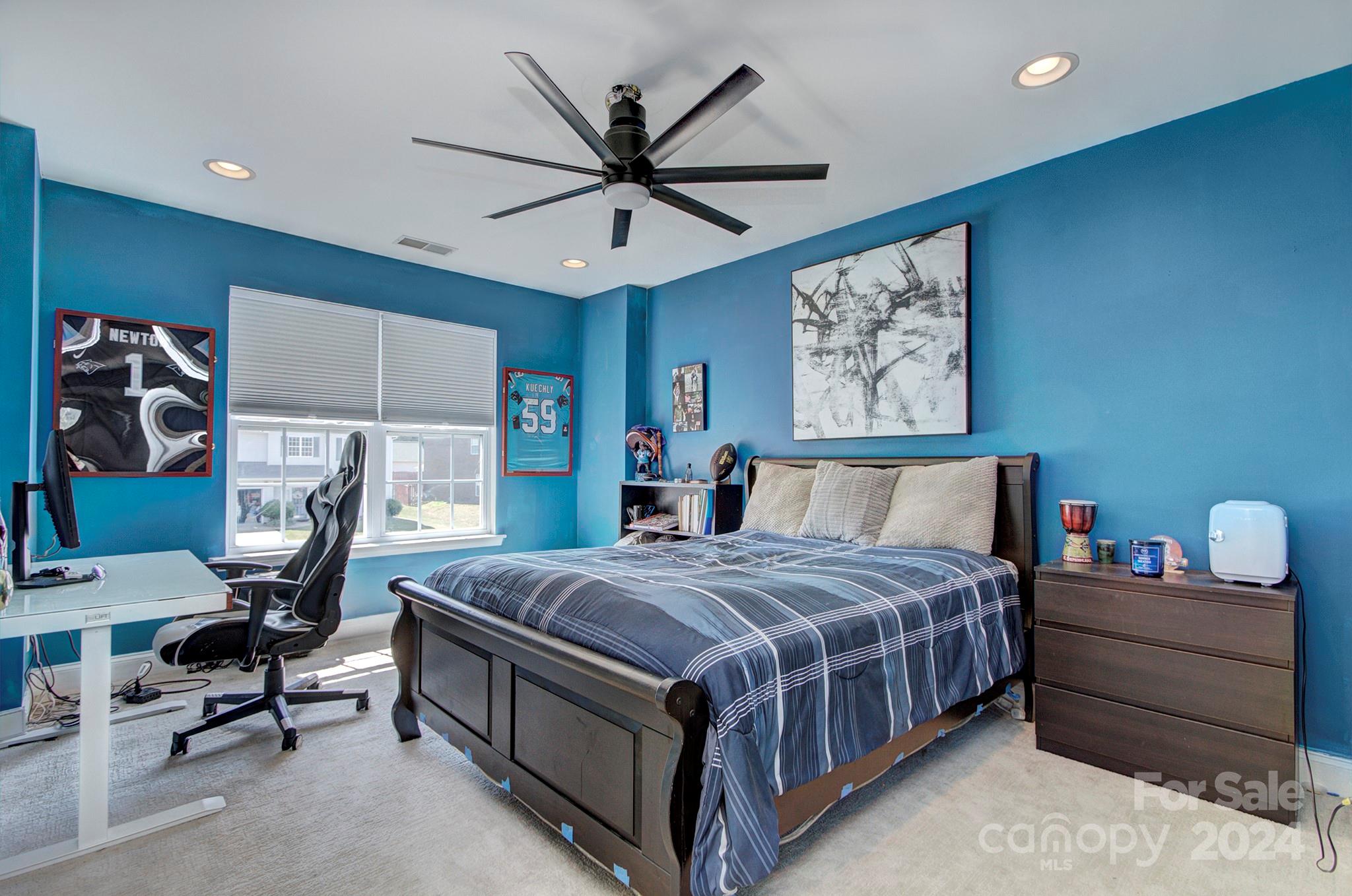 144 Lighthouse Road Mount Holly, NC 28120 - Photo 18 of 48 a bedroom with a bed and a chandelier