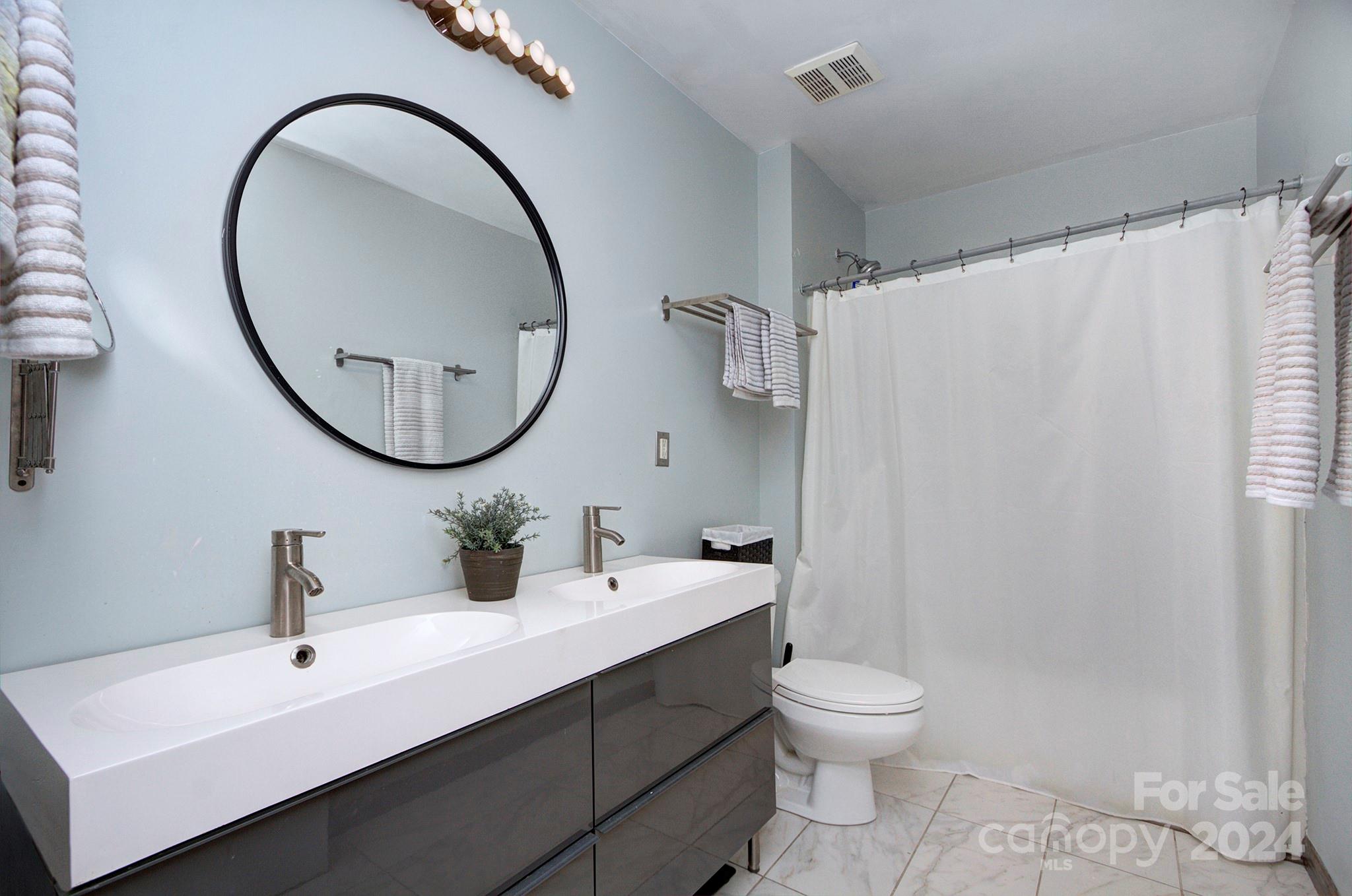 144 Lighthouse Road Mount Holly, NC 28120 - Photo 19 of 48 a bathroom with a toilet a sink and a mirror