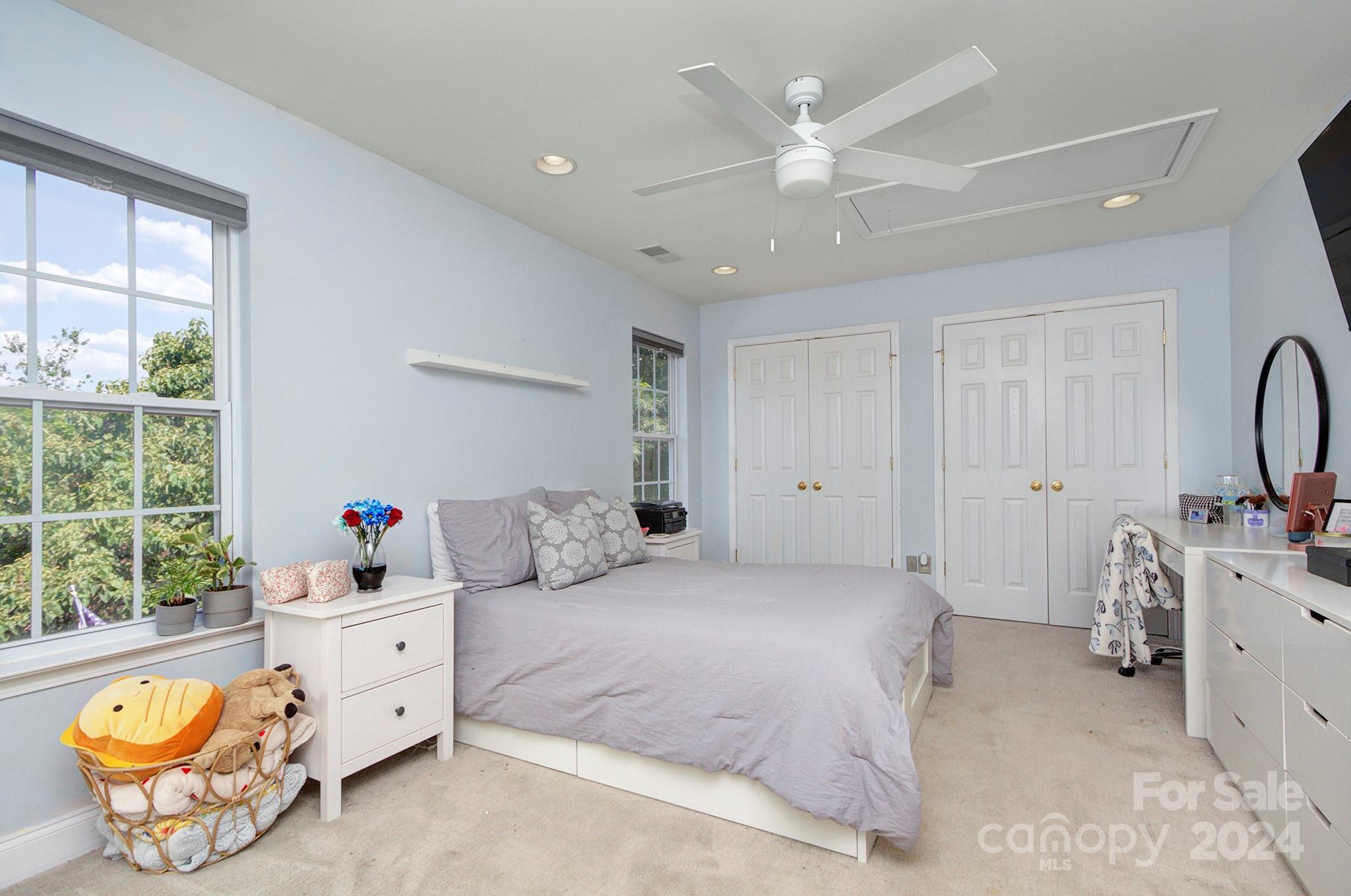 144 Lighthouse Road Mount Holly, NC 28120 - Photo 20 of 48 a bedroom with a bed and a chandelier