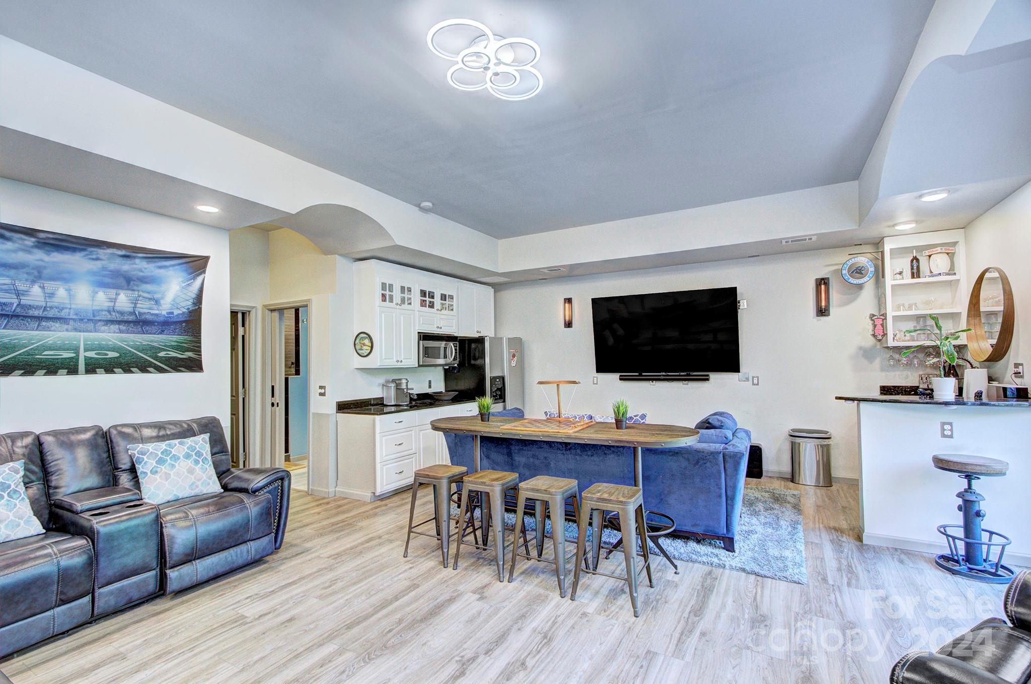 144 Lighthouse Road Mount Holly, NC 28120 - Photo 26 of 48 a living room with furniture a flat screen tv and kitchen view