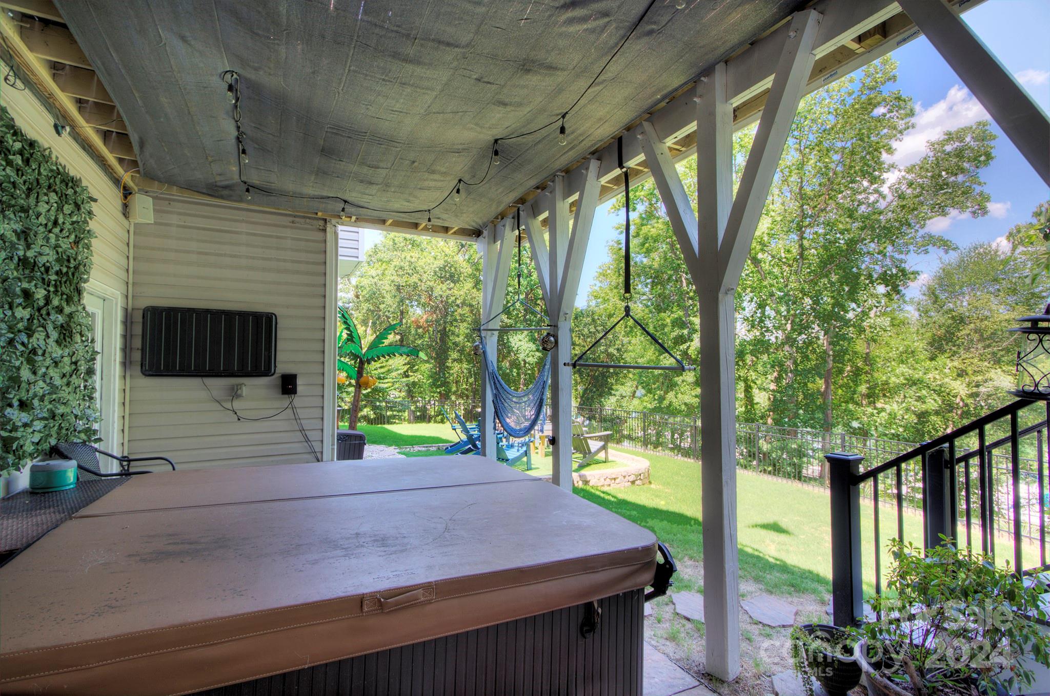 144 Lighthouse Road Mount Holly, NC 28120 - Photo 31 of 48 a view of a patio with table and chairs potted plants and large tree