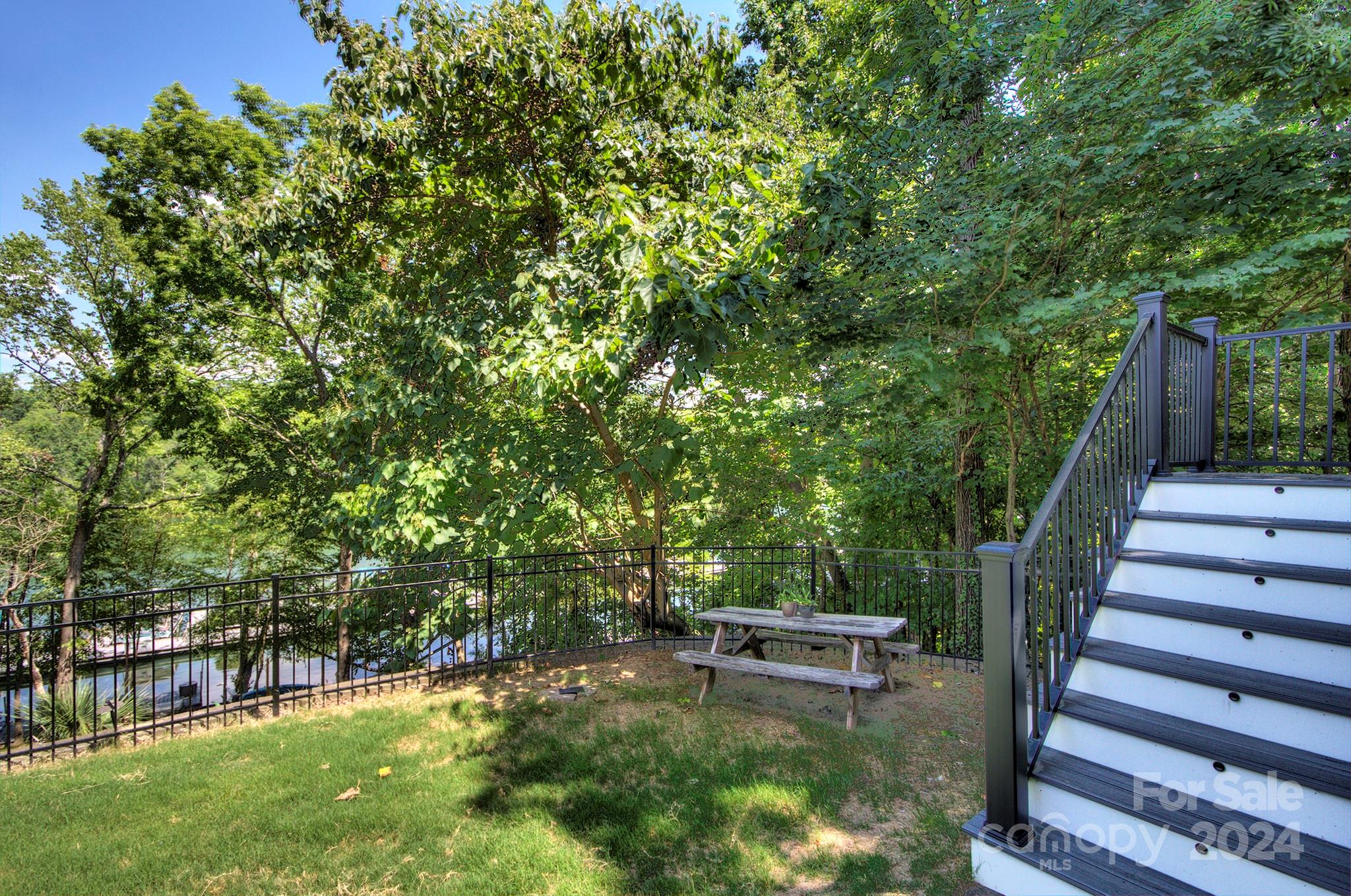 144 Lighthouse Road Mount Holly, NC 28120 - Photo 34 of 48 a view of a backyard with lawn chairs and a large tree