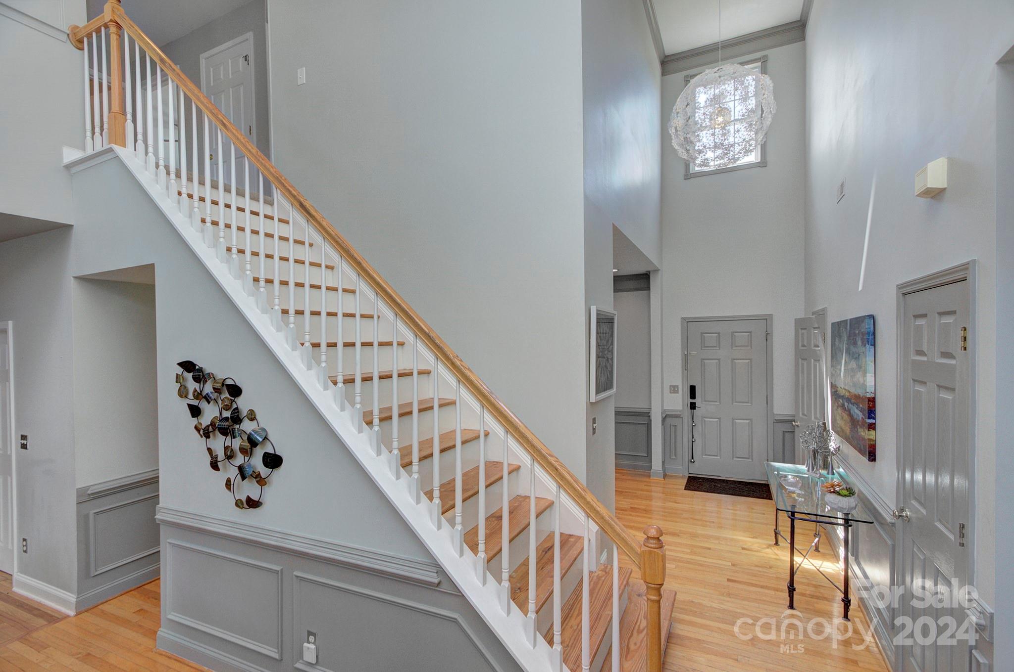 144 Lighthouse Road Mount Holly, NC 28120 - Photo 4 of 48 a view of staircase with lots of frames on wall and a chandelier