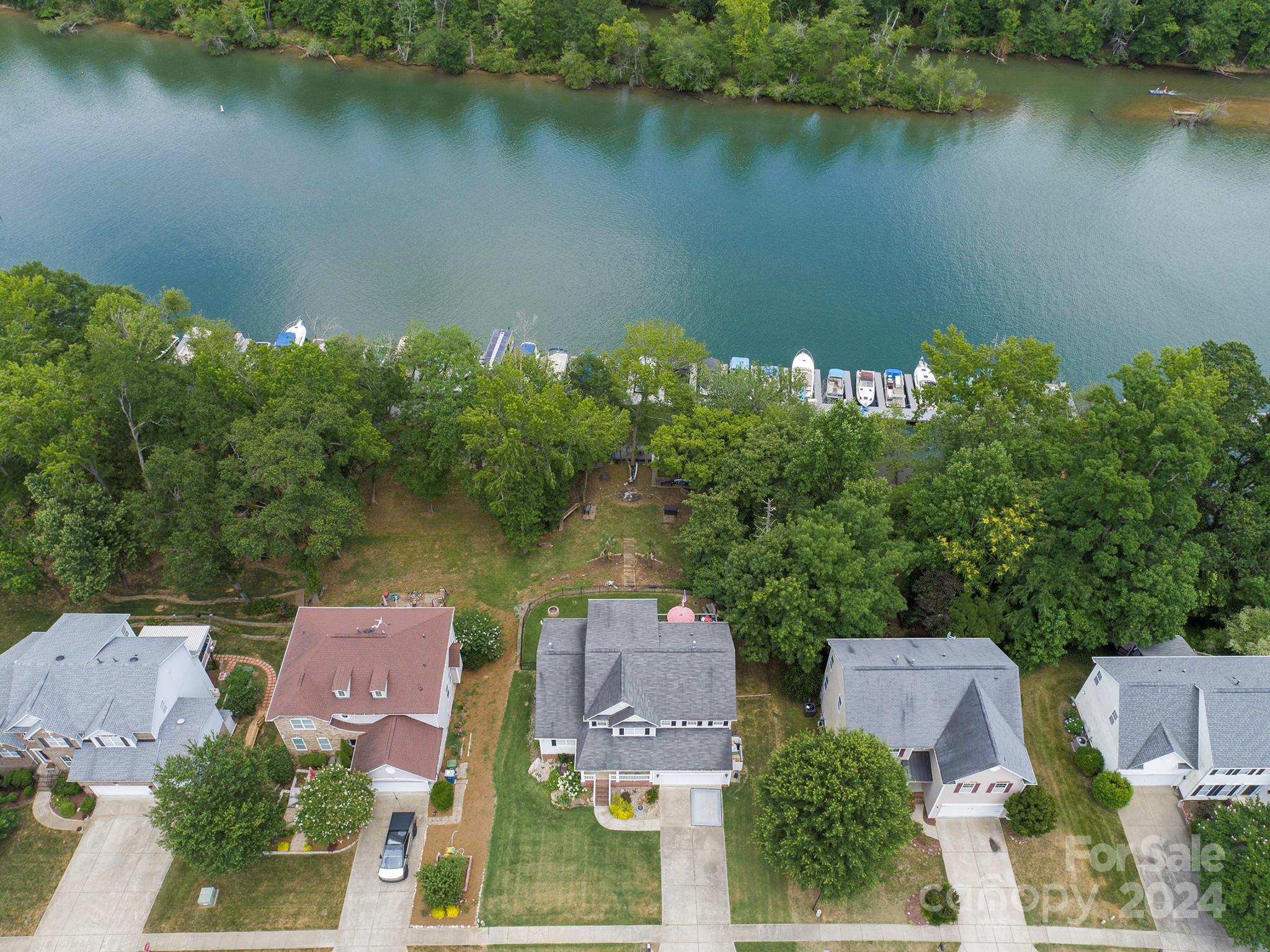 144 Lighthouse Road Mount Holly, NC 28120 - Photo 42 of 48 an aerial view of a house with a lake view