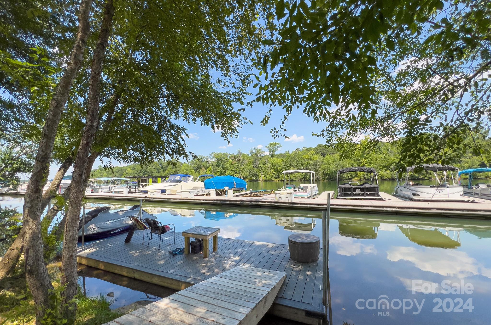 144 Lighthouse Road Mount Holly, NC 28120 - Photo 46 of 48 a view of a swimming pool with a lawn chairs under an umbrella