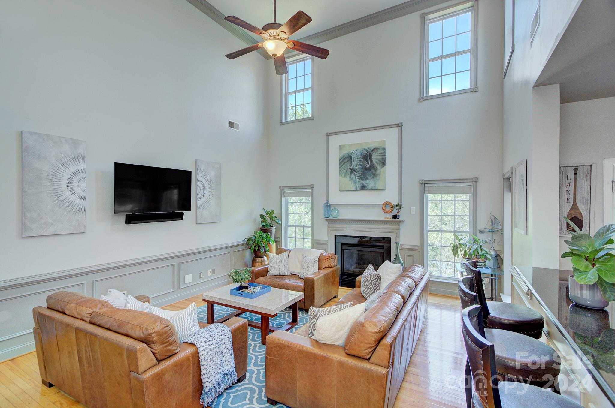 144 Lighthouse Road Mount Holly, NC 28120 - Photo 10 of 48 a living room with furniture a flat screen tv and a fireplace