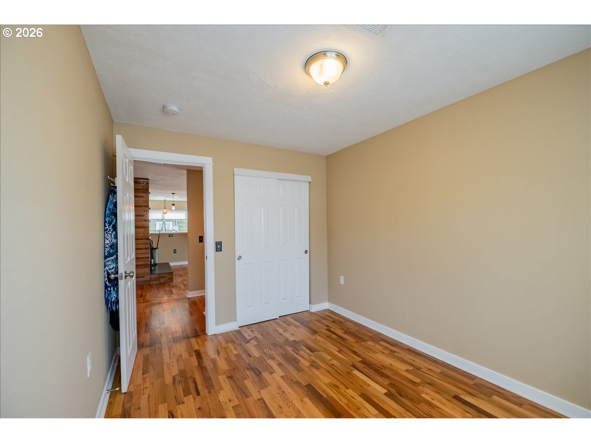 32973 Tennessee Road Southeast Lebanon, OR 97355 - Photo 21 of 36 a view of empty room with wooden floor