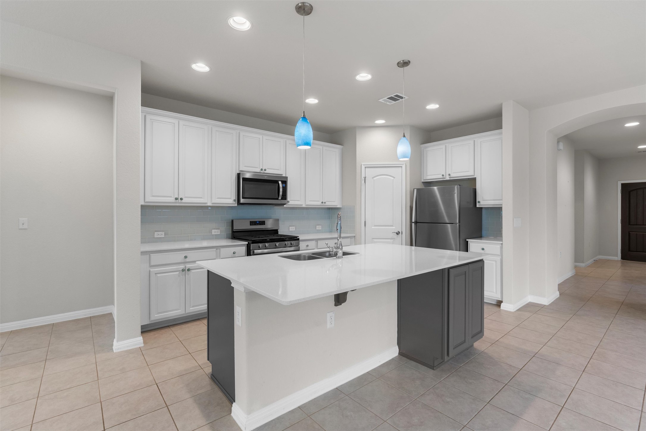 108 Calhoun Lane Georgetown, TX 78633 - Photo 11 of 32 a kitchen with a sink a counter top space and stainless steel appliances