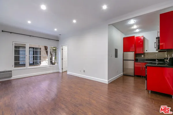 a view of kitchen with stainless steel appliances granite countertop a stove and a refrigerator