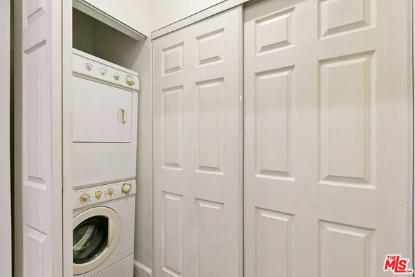 a view of a hallway with washer and dryer