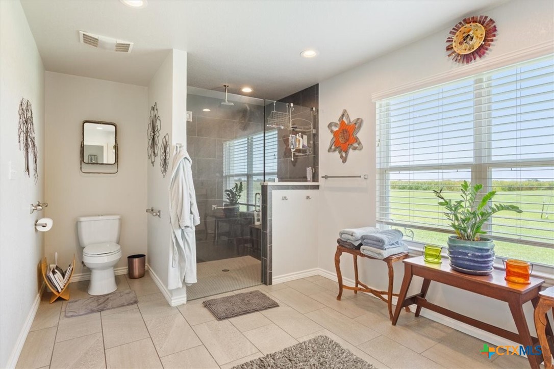 17179 Cyclone Road Burlington, TX 76519 - Photo 21 of 39 a spacious bathroom with a toilet a sink and a shower