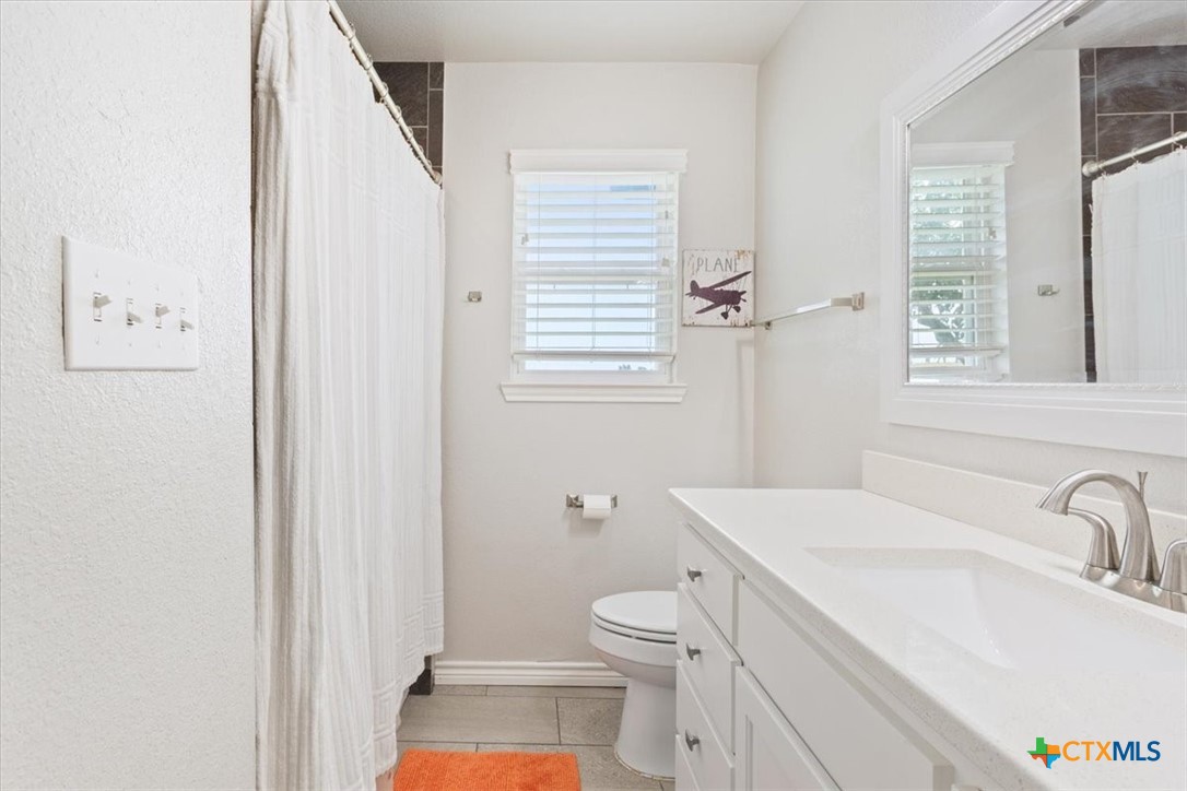 17179 Cyclone Road Burlington, TX 76519 - Photo 24 of 39 a bathroom with a sink toilet and shower
