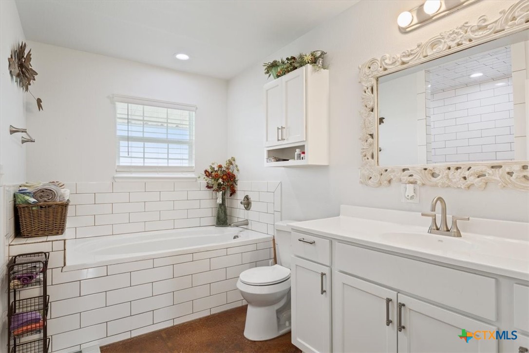 17179 Cyclone Road Burlington, TX 76519 - Photo 33 of 39 a bathroom with a sink a toilet and shower