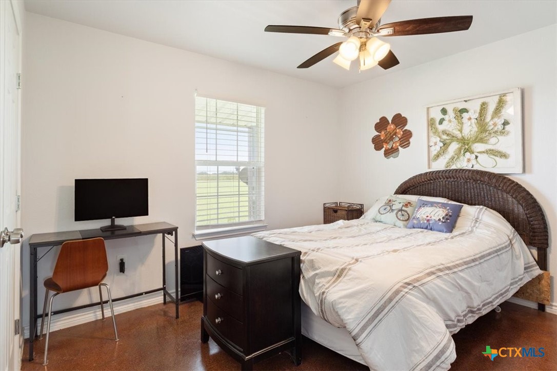 17179 Cyclone Road Burlington, TX 76519 - Photo 35 of 39 a bedroom with a bed and a flat screen tv