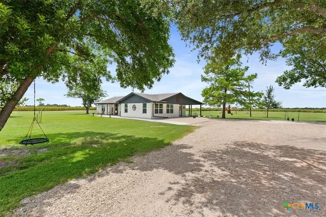a view of street with houses and trees in the background