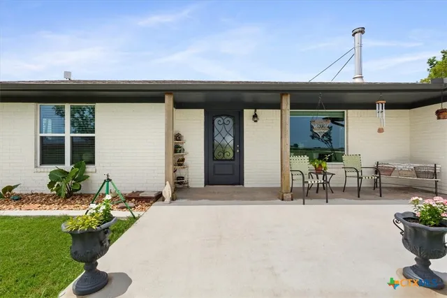 a front view of a house with outdoor seating