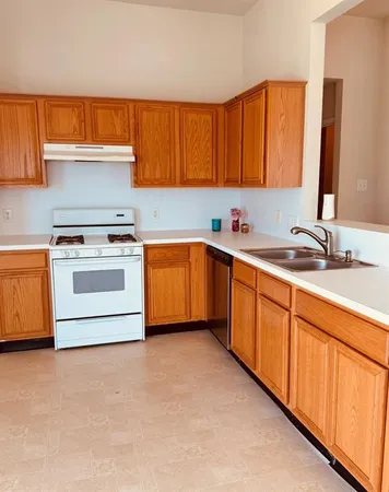 a kitchen with stainless steel appliances a stove sink and cabinets