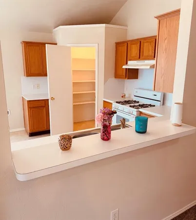 a kitchen with stainless steel appliances a sink stove and window