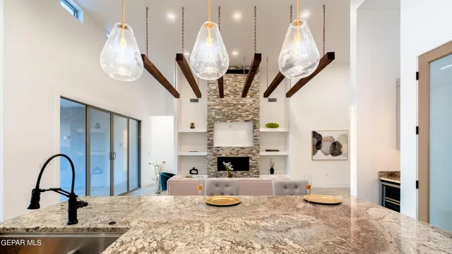 a kitchen with stainless steel appliances granite countertop a stove and a wooden floor