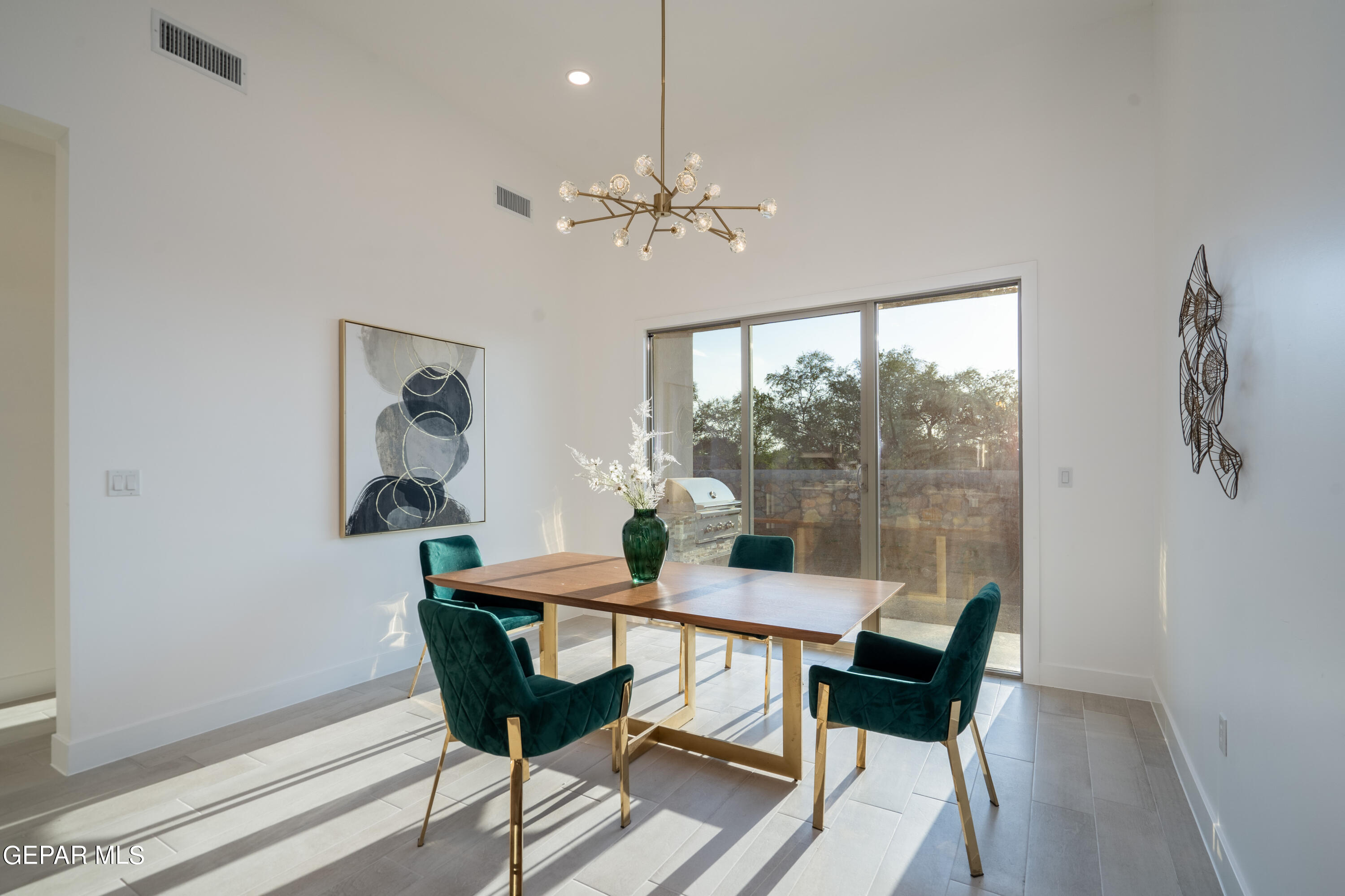 5692 Rio Bonito Circle El Paso, TX 79932 - Photo 19 of 46 a dining room with furniture a chandelier and wooden floor