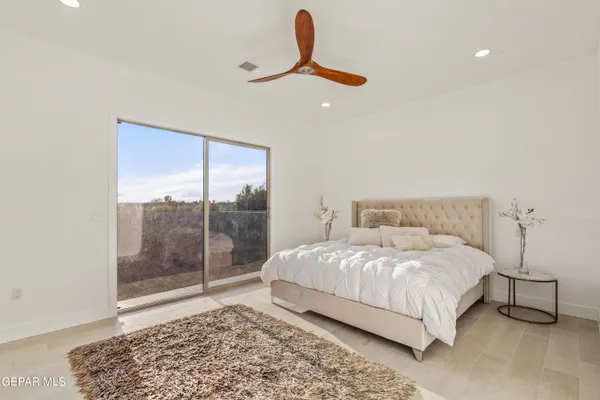 a bedroom with a bed lamp and window