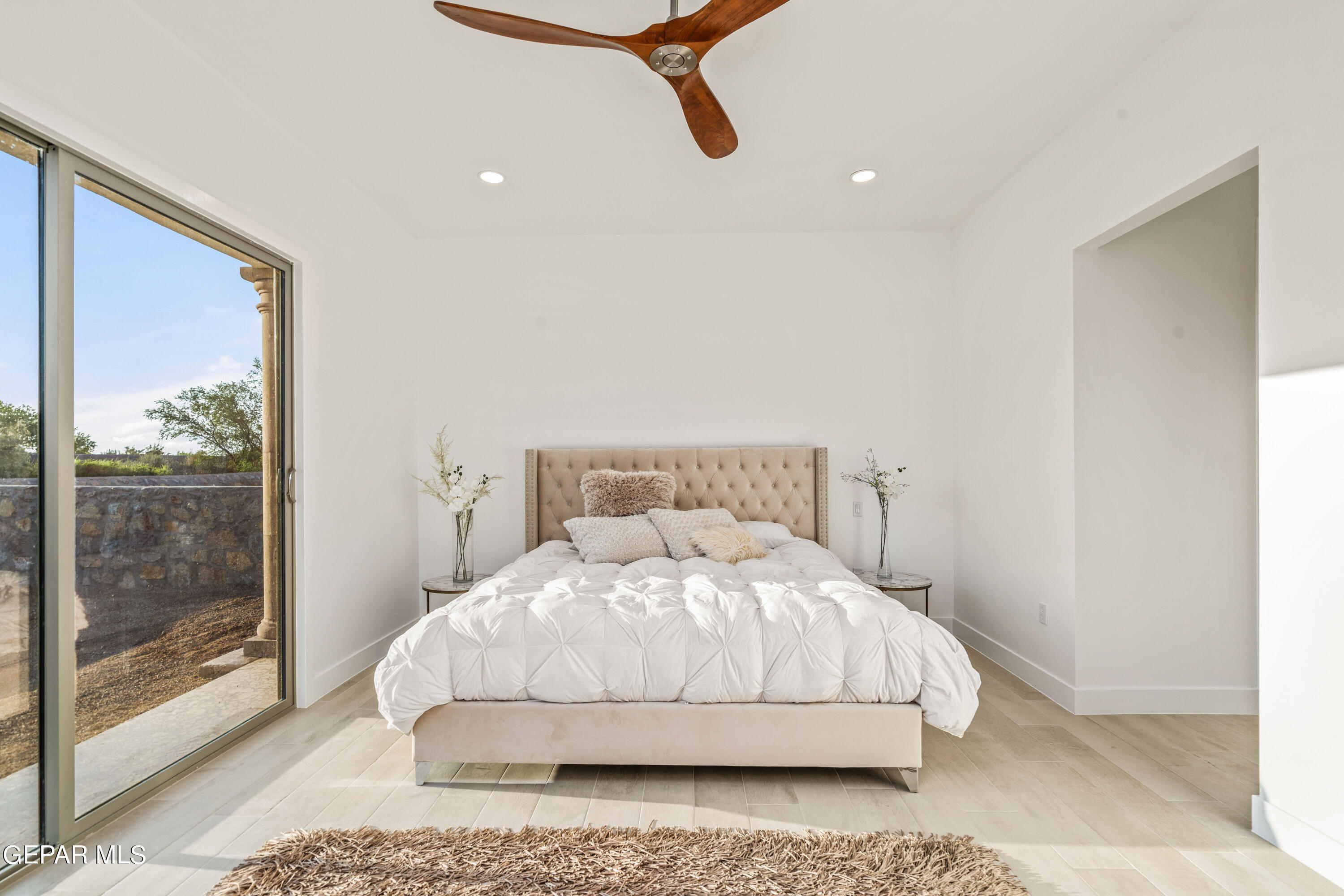 5692 Rio Bonito Circle El Paso, TX 79932 - Photo 22 of 46 a bedroom with a bed and glass door