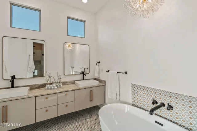 a spacious bathroom with a double vanity sink mirror and toilet