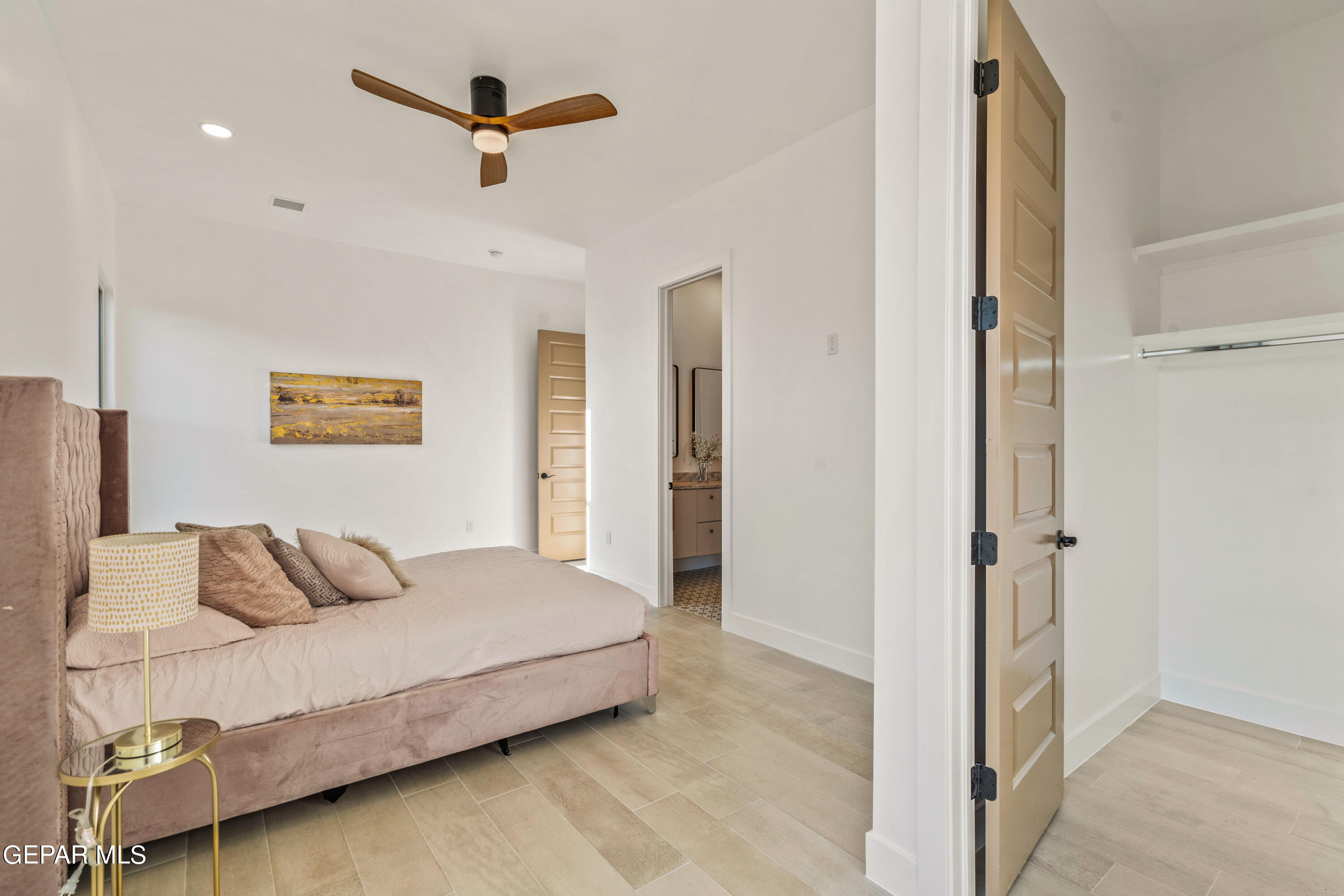 5692 Rio Bonito Circle El Paso, TX 79932 - Photo 28 of 46 a bedroom with a bed and a ceiling fan