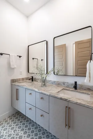 a bathroom with a granite countertop sink and a mirror