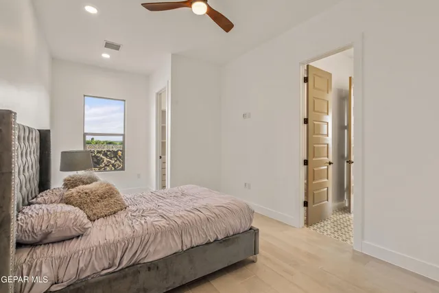 a bedroom with a bed and a painting on the wall