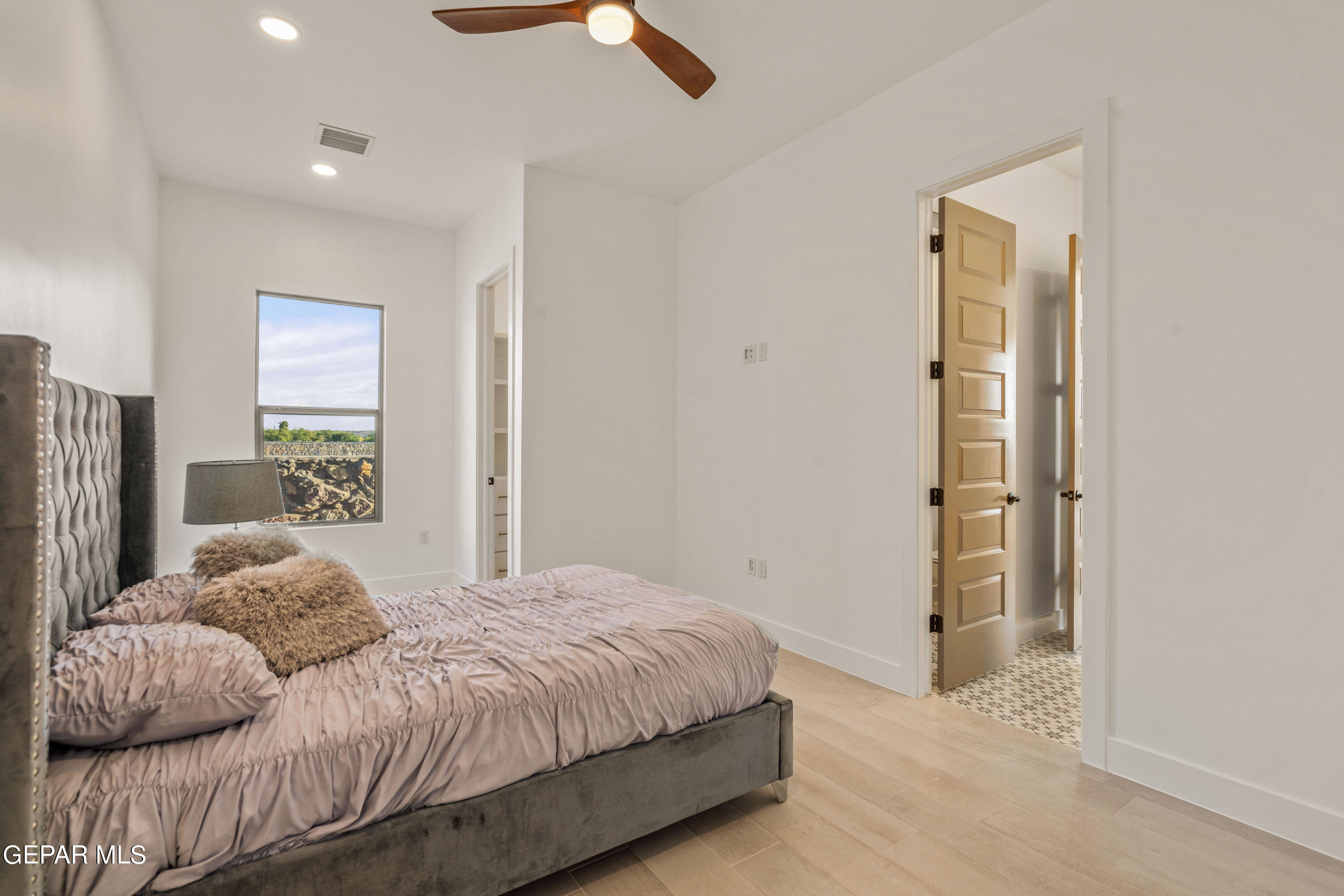 5692 Rio Bonito Circle El Paso, TX 79932 - Photo 33 of 46 a bedroom with a bed and a painting on the wall