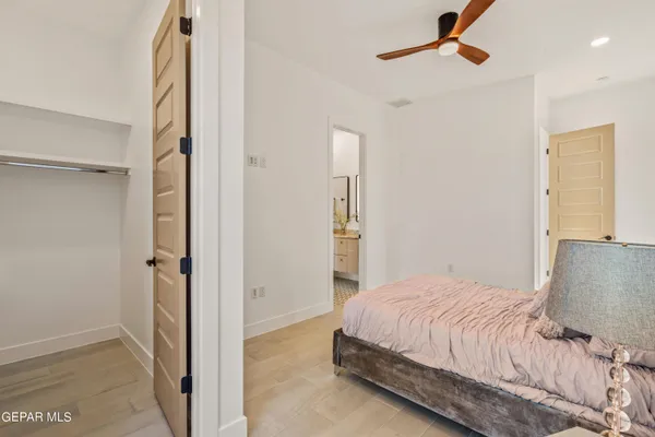 a bedroom with a bed and a walk in closet