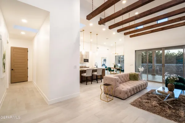 a living room with furniture and a floor to ceiling window