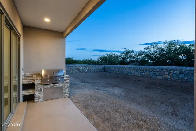 a view of a room with a kitchen