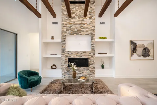 a living room with fireplace furniture and decor