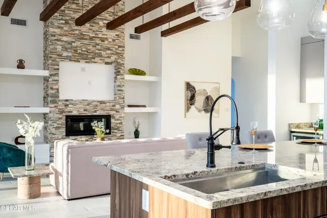 a kitchen with a granite counter top a stove and a sink