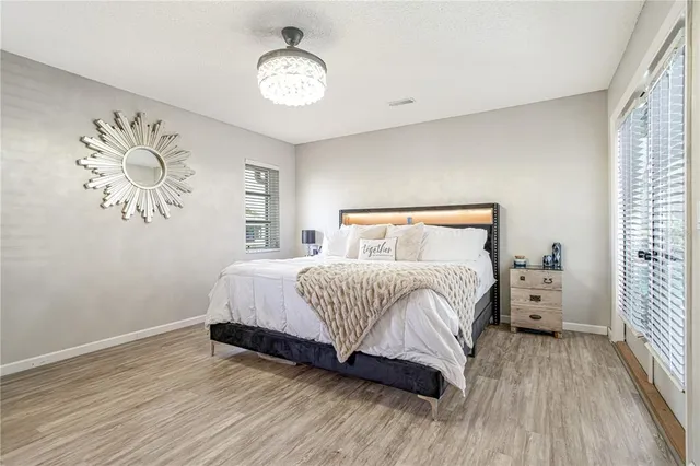 a bedroom with a bed and a chandelier