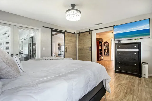 a spacious bedroom with a bed and a dresser