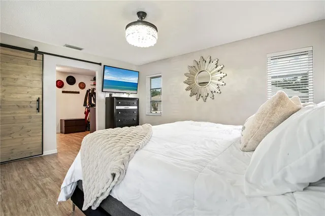 a bedroom with a bed and a chandelier