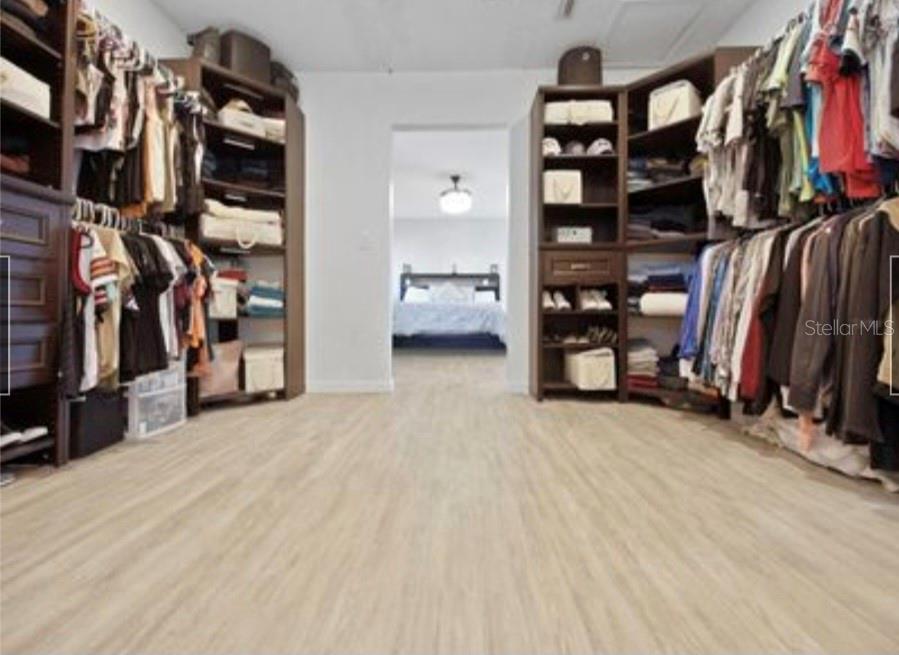 5807 Garfield Road Venice, FL 34293 - Photo 18 of 40 a view of walk in closet with clothes and shoes