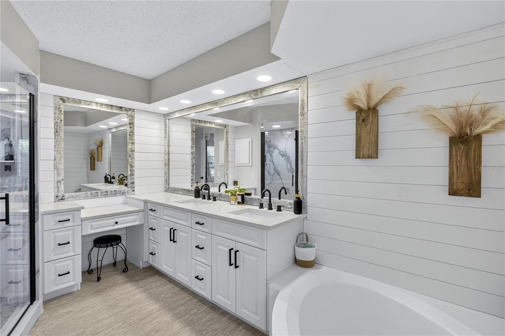 5807 Garfield Road Venice, FL 34293 - Photo 19 of 40 a bathroom with a double vanity sink toilet mirror and bathtub