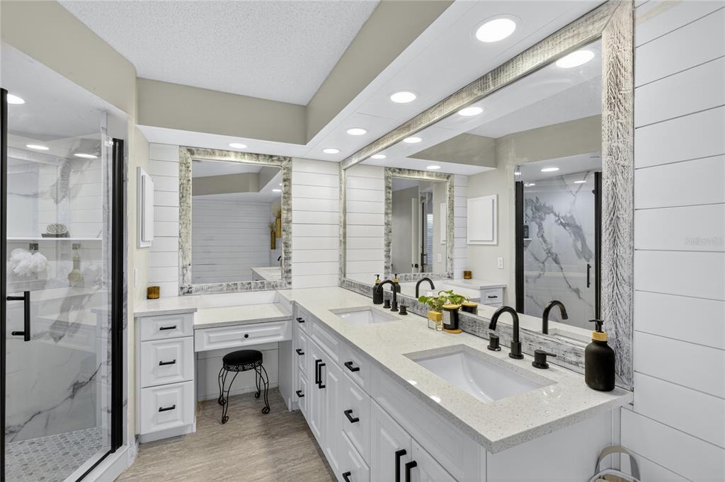 5807 Garfield Road Venice, FL 34293 - Photo 20 of 40 a bathroom with a double vanity sink mirror and shower