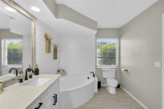 a bathroom with a bathtub sink and toilet
