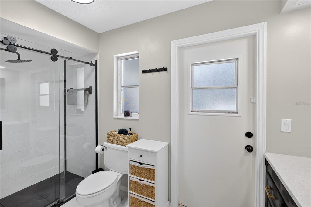 5807 Garfield Road Venice, FL 34293 - Photo 26 of 40 a bathroom with a toilet a sink and shower