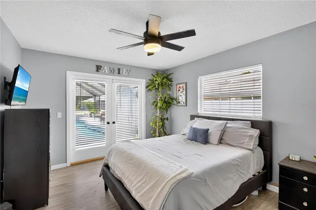 a bedroom with a large bed and a chandelier