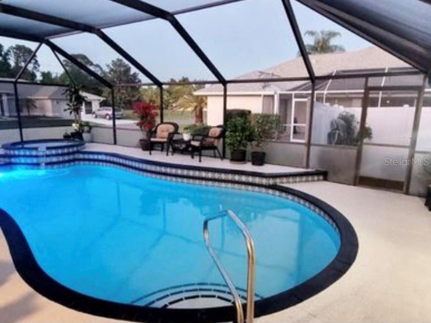 5807 Garfield Road Venice, FL 34293 - Photo 32 of 40 a view of a swimming pool with a porch